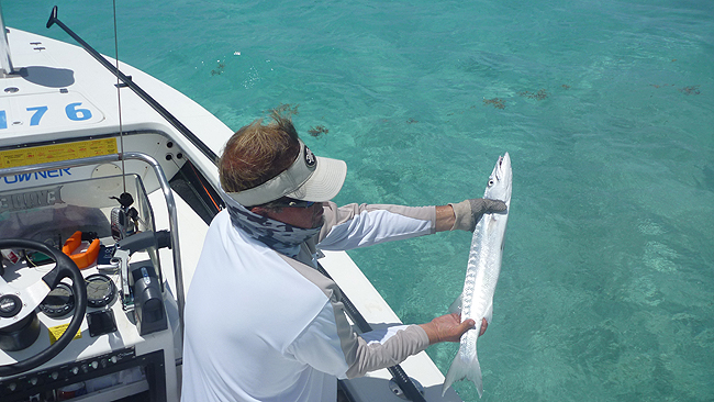 Ian with a juvenile 'cuda.JPG
